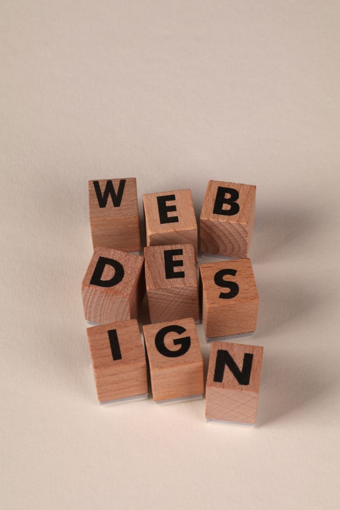 Wooden blocks arranged to spell Web Design. Ideal for creative, digital content themes.